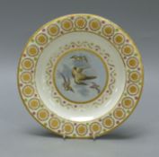 A Crown Derby plate painted with birds, c.1810, diameter 24.5cm