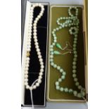 A single row uniform cultured pearl necklace with 9ct gold ball clasp, a graduated jade bead
