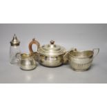 A George V silver teapot, Birmingham, 1913, a similar cream jug and sugar bowl and a silver mounted