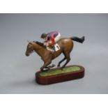 A Cameron Sculptures cold-painted bronze model of a racehorse with jockey up, height 16.5cm