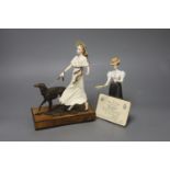 An Albany Fine China Deauville ceramic and bronze group of a girl with borzoi on walnut and