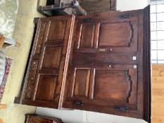 An 18th century panelled oak two part bacon cupboard, width 140cm, depth 50cm, height 175cm