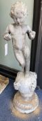 A Victorian lead garden ornament of a putto on orb, height 80cm