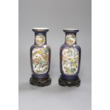 A pair of Chinese Kangxi style blue-ground vases, late 19th century decorated with panels of