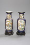 A pair of Chinese Kangxi style blue-ground vases, late 19th century decorated with panels of