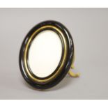 A Must de Cartier black lacquered and gilt oval easel photograph frame, length 9cm