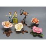 Four Boehm porcelain and bronzed metal roses, a similar model of a bullfinch eating berries and a