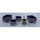 A pair of Edwardian pierced silver quatrefoil shaped salts with blue glass liners, London, 190987mm