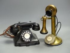 A vintage stick telephone and a black Bakelite telephone