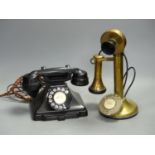 A vintage stick telephone and a black Bakelite telephone