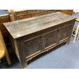 An early 18th century carved panelled oak coffer, length 143cm, depth 56cm, height 73cm