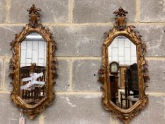 A pair of carved giltwood wall mirrors, width 30cm, height 74cm