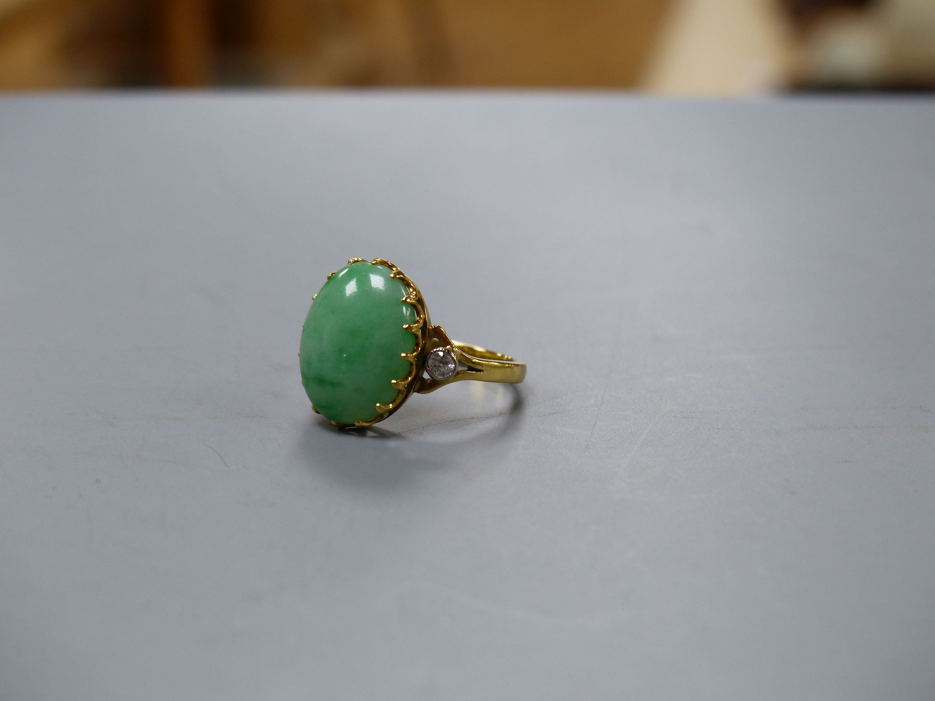 A jade and diamond dress ring, 18ct yellow gold setting,the oval cabochon jade flanked by two small - Image 3 of 3