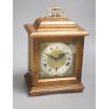 A modern walnut mantel clock, with German striking and chiming movement, height 29cm