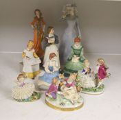 A German porcelain group of two children by a tree stump, on rocky base, two 'crinoline' figures