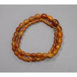 A single strand graduated oval amber bead necklace, 48cm, gross weight 17 grams.