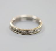 A modern 18ct white gold (worn) and nine stone channel set diamond half eternity ring, size P,gross