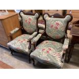 A pair of late Victorian mahogany upholstered armchairs