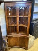 A Georgian style mahogany floor-standing corner display cabinet,having concave front, fitted a pair