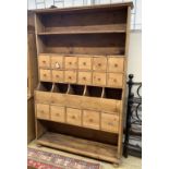 A Victorian pine grocer's shop cabinet,fitted seventeen drawers and open shelves, on bun feet,