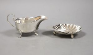 A George V silver butter shell, 13.2cm and a similar sauceboat by Mappin & Webb,160 grams.