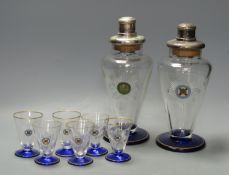 A pair of Art Deco cobalt blue and gilt-mounted tapered glass cocktail shakers, c.1920, enamelled