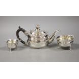 A George V silver teapot with floral finial, London, 1927 together with an associated cream jug,