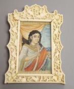 An Indian miniature gouache on ivory in a Chinese Ivory frame, circa 1900of a figure smoking a