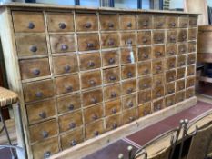 A Victorian style pine apothecaries bank of 80 small drawers, width 147cm, depth 25cm, height 79cm