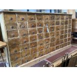 A Victorian style pine apothecaries bank of 80 small drawers, width 147cm, depth 25cm, height 79cm