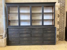 A Victorian painted pine glazed cabinet fitted twenty drawers, by repute The Bible Cabinet from