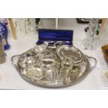 A collection of silver-plated wares to include an oval drinks tray, a cocktail shaker, serving
