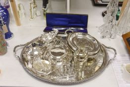 A collection of silver-plated wares to include an oval drinks tray, a cocktail shaker, serving