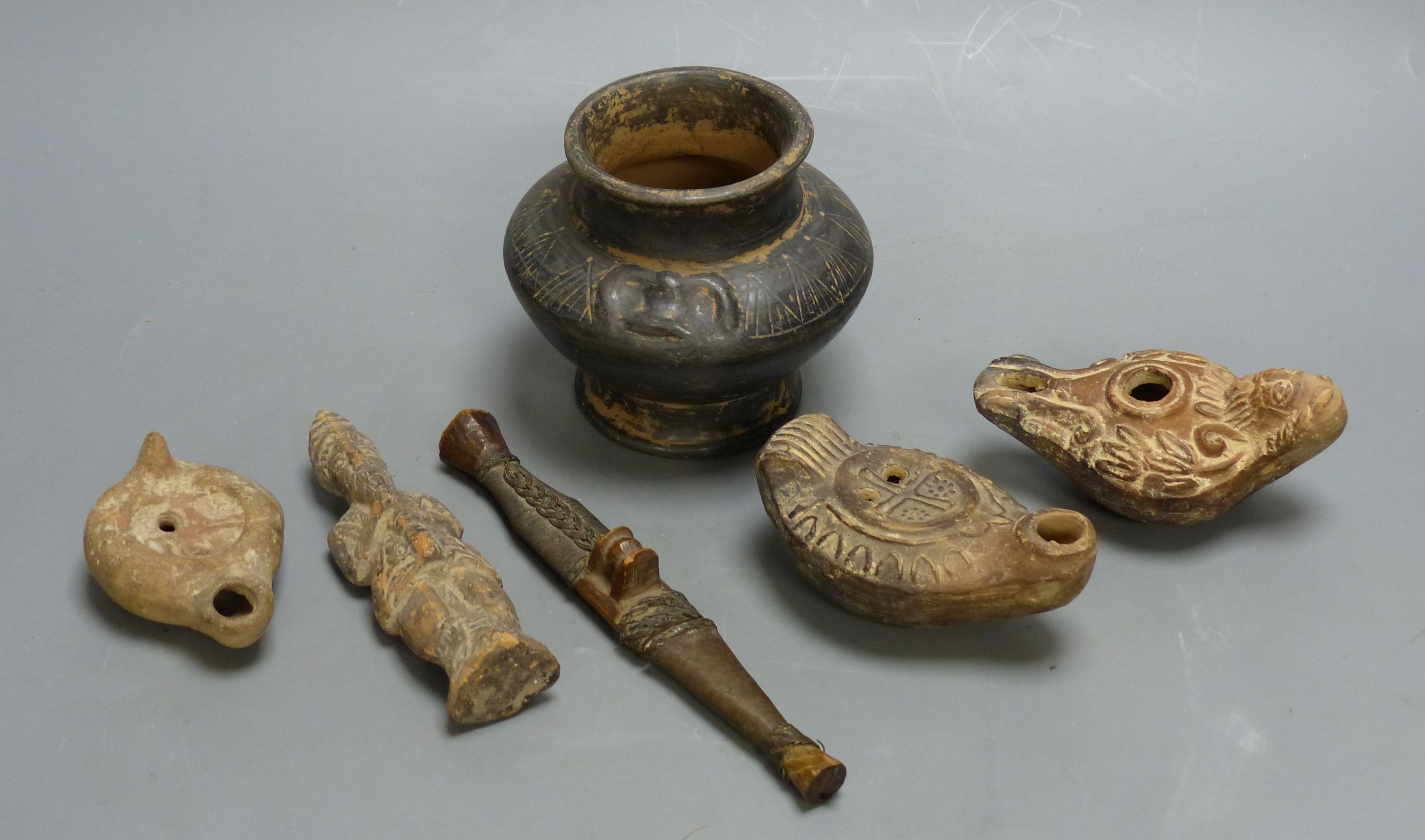 A group of antiquities, three oil lamps, a vase and a figure, etc.