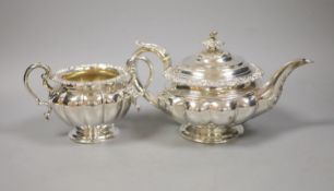 A large Georgian silver teapot, marks rubbed, with an associated twin handled sugar basin,