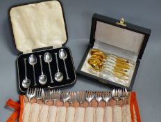 A set of twelve Christofle forks, a cased set of English coffee spoons and a set of Solingen gold-