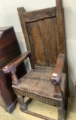 A 17th century oak panelled back armchair, length 67cm, depth 58cm, height 134cm