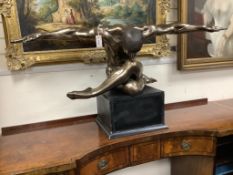 A contemporary bronzed composition figure of a seated male nude, width 138cm, height 68cm