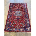 A Tabriz red ground medallion rug, 250 x 153cm