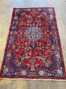 A Tabriz red ground medallion rug, 250 x 153cm