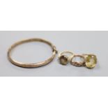 Three assorted 9ct and gem set rings and a 9ct gold hinged bangle,gross 18.1 grams.