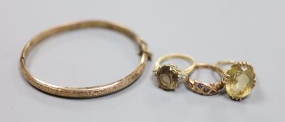 Three assorted 9ct and gem set rings and a 9ct gold hinged bangle,gross 18.1 grams.