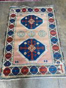 A Kazak style peach ground rug, 180 x 126cm