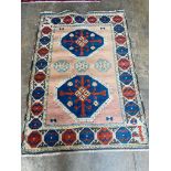 A Kazak style peach ground rug, 180 x 126cm