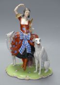 An Art Deco Fraureuth group modelled as a lady wearing a red gown flanked by two Borzoi dogs,on