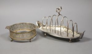 A late Victorian silver seven bar toastrack, with shaped ring handle, on paw feet, Josiah