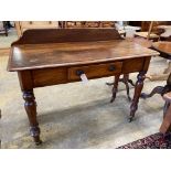 A Victorian mahogany writing tablefitted two small drawers on turned tapered legs, length 106cm,
