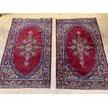 A pair of North West Persian burgundy ground rugs, 160 x 98cm