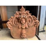 A terracotta cherub head garden wall plaque, width 54cm, height 54cm