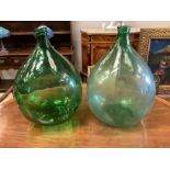 A pair of green glass carboys, height 62cm
